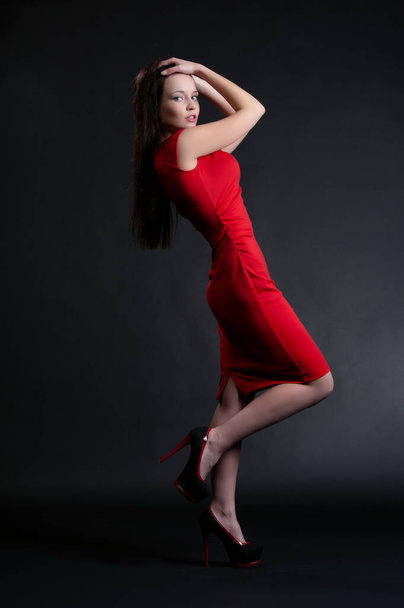 Beautiful sexy brunette girl posing on a black background - Fotografie, Obrázek