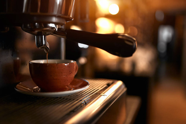 modern coffee machine makes a cup of strong coffee - Fotó, kép