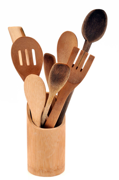 Wooden cutlery in a pot close-up on white background  - Photo, Image
