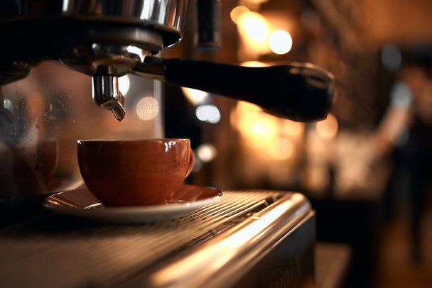tasty espresso pouring into a cup - Fotó, kép