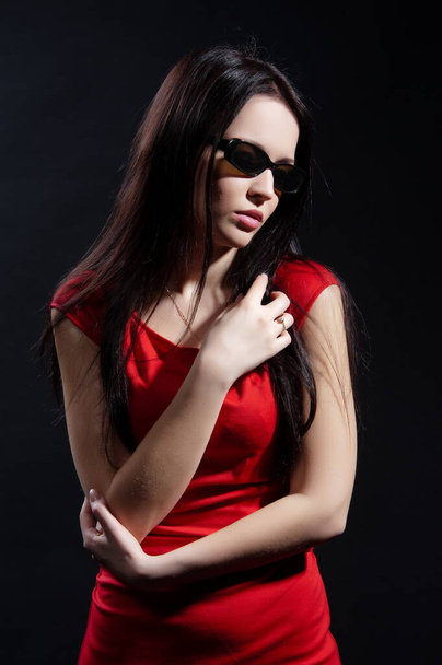 Beautiful sexy brunette girl posing on a black background - Фото, изображение