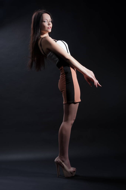 Beautiful sexy brunette girl posing on a black background - Valokuva, kuva