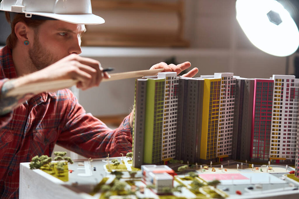 ambitious man creates a complete model of a building - Фото, зображення