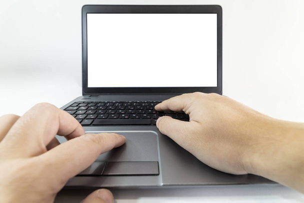 Low angle pow view of a man typing on a laptop keyboard - Zdjęcie, obraz