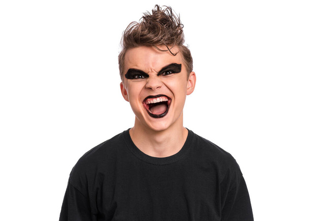 Rebellious teen boy dressed in black, isolated on white background. Angry screaming teenager in style of punk goth wearing black t-shirt, shouting. Problems of transitional age. - Zdjęcie, obraz
