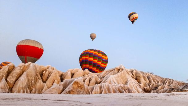 Hot air balloons preparing to fly at early morning in winter season in Cappadocia, Turkey - Фото, зображення
