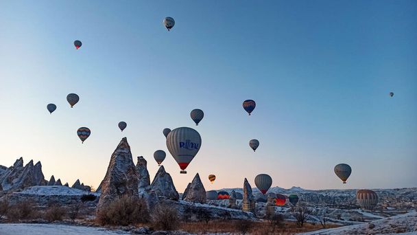 Hot air balloons preparing to fly at early morning in winter season in Cappadocia, Turkey - Fotoğraf, Görsel