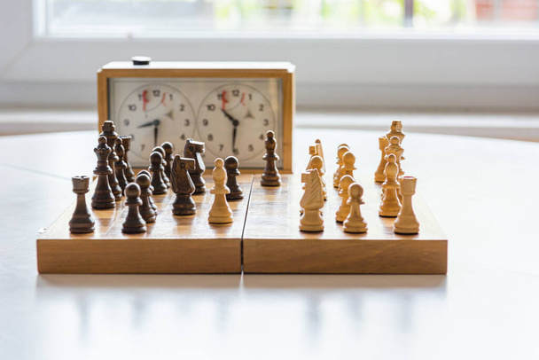 Playing a game of chess with wooden figures. - Foto, Bild