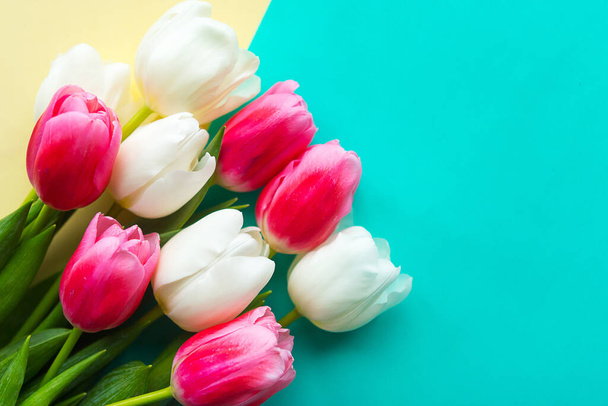 Bouquet of white and pink tulips on color background, copy space for the text - Φωτογραφία, εικόνα