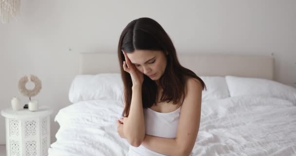 Disturbed woman lying awake in bed suffer from insomnia headache - Materiał filmowy, wideo