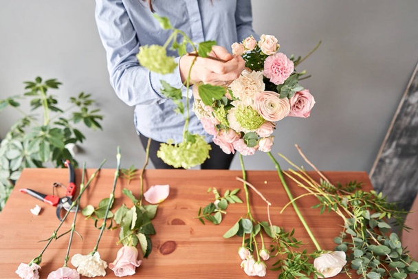 Education in the school of floristry. Master class on making bouquets. Summer bouquet. Learning flower arranging, making beautiful bouquets with your own hands. Flowers delivery - Photo, Image