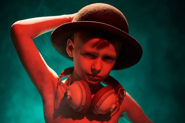 Little boy in retro hat bowler hat and headphones - Fotó, kép
