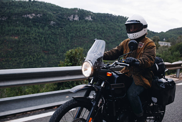 Motorcycle rider on empty epic mountain road - Photo, Image
