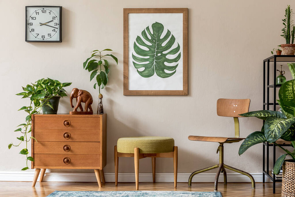 Stylish room design with vintage commode, potted plants and beautiful drawings - Photo, image