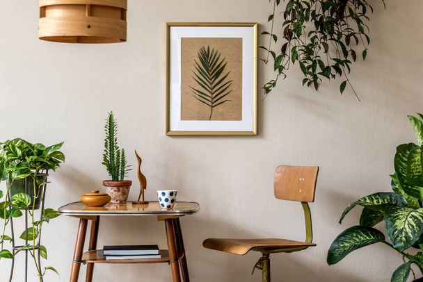 Stylish room design with vintage commode, potted plants and beautiful drawings - Fotó, kép