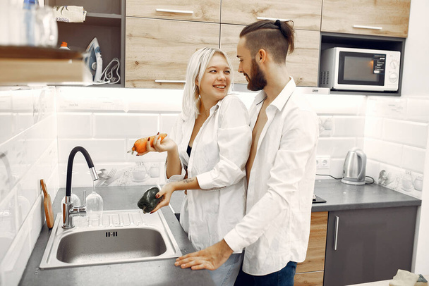 COUPLE COOKING DINNER IN THE KITCHEN - Foto, Imagen