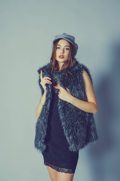 magnificent portrait of a beautiful young woman. Perfect face beautiful girl portrait. brunette girl. Girl in a gray hat. little black dress. Girl in a vest with faux fur. - Φωτογραφία, εικόνα