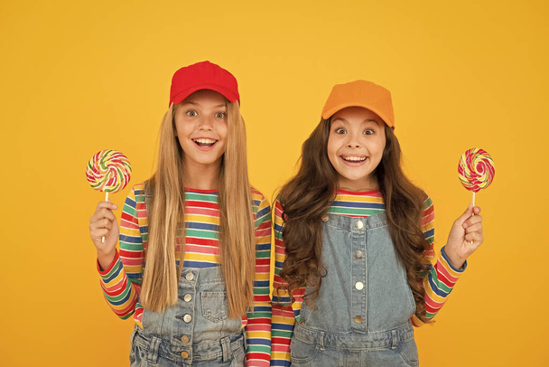 Happy kids. Calories and nutritional value. Sugar free treats. Happy childrens day. Holiday celebration. Happy girls hold lollipop candy. Join celebration. Child care. Healthy nutrition sweet treats - Fotoğraf, Görsel
