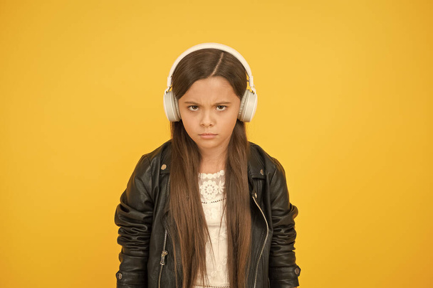 Perception of sounds. Learning lyrics. Music trends shaping future. Musical taste. Musical accessory. Gadget shop. Small girl listening music wireless headphones. Stereo sound. Musical education - Photo, image
