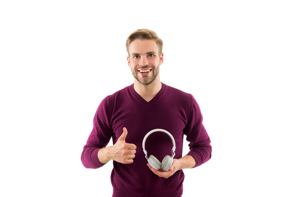 Cheerful male customer service operator showing thumbs up. leisure time. guy in headphones giving thumb up. happy music lover. guy listen to music. best quality device in our shop. just perfect - Photo, image