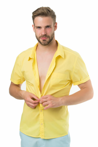 Heat season. Modern fashion. Dressing room. Attractive man taking off shirt. Confident in his appealing. Bearded guy casual style. Handsome macho fashion model. Sexy macho shopping clothes. Hot day - Photo, image
