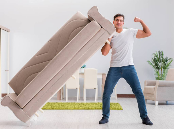 Homme déménageant des meubles à la maison
 - Photo, image