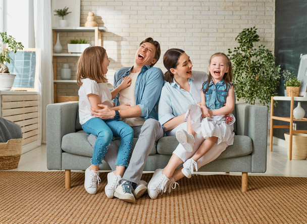 Happy family! Two children daughters with mother and father. Mum, dad and girls laughing and hugging.  - Φωτογραφία, εικόνα
