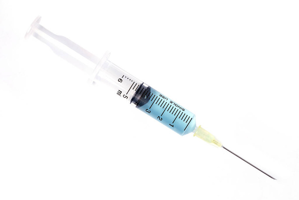 Syringe closeup with blue serum isolated on white background. - Photo, Image