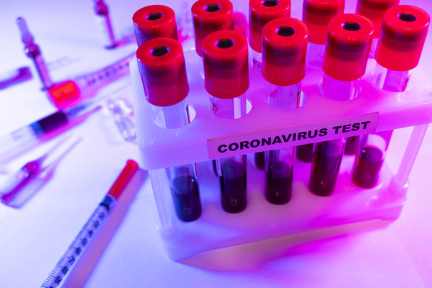 Coronavirus blood test concept. Analyzing blood sample in test tube for coronavirus test. Test tube with blood for 2019-nCoV analyzing. Coronavirus blood analysis concept. - Fotoğraf, Görsel