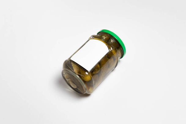 Glass jar with Pickled Cucumbers on white background with blank label.Marinated cucumbers in a mason jar.High-resolution photo. - Fotografie, Obrázek