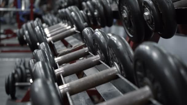 Rack with dumbbells in fitness gym - Footage, Video