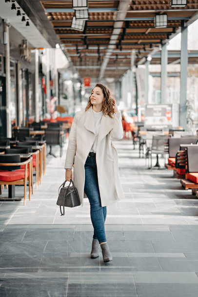 trendy girl posing at the city in street fashion style - Photo, Image