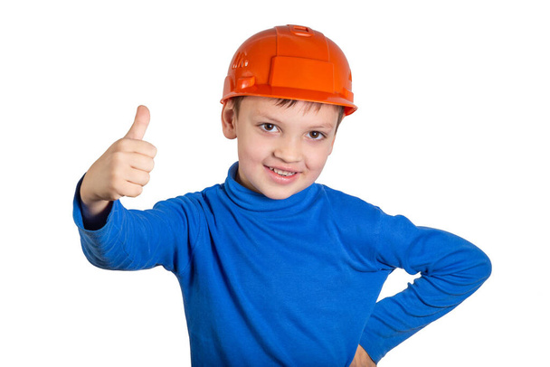 Child showing a thumbs up gesture in the builder hat. - Foto, Imagen