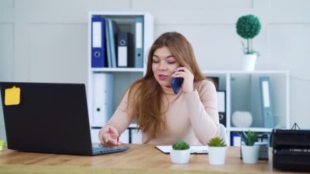 Serious young girl making business call in office - Video