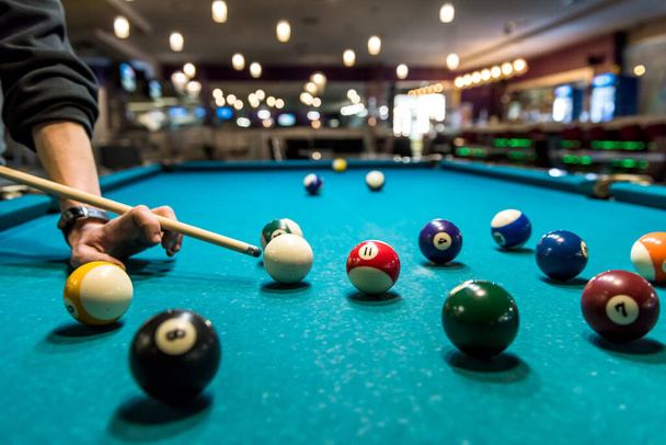 Billiard balls and hand with cue close up - Φωτογραφία, εικόνα