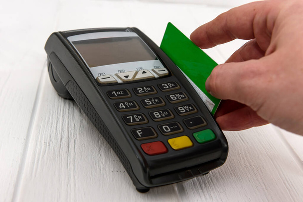 Hand with credit card and banking terminal - Photo, Image