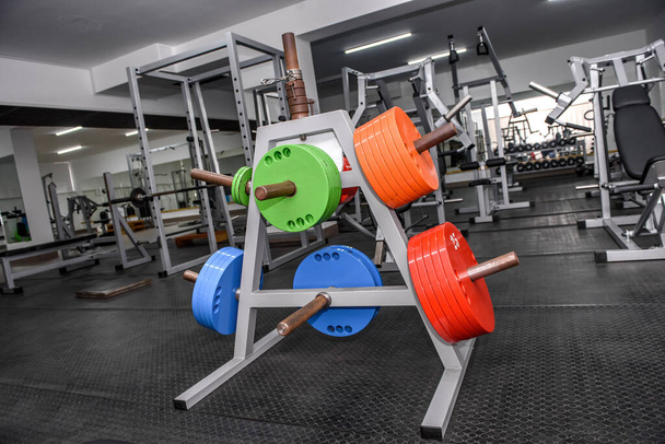 Different colour weights for barbells in gym  - Photo, Image