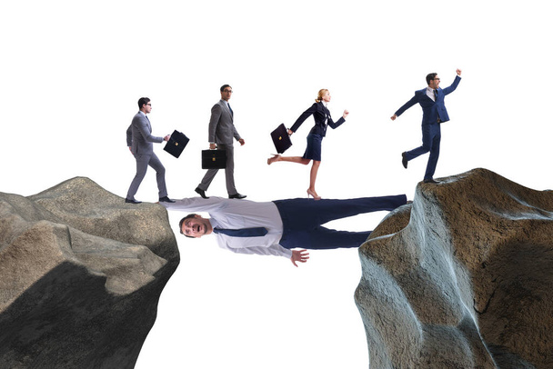 Businessman acting as a bridge in support concept - Photo, Image