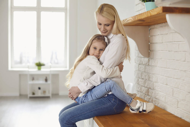Happy mothers day. Mother and daughter hugging smiling in home. - Fotografie, Obrázek