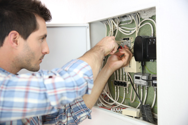 Electrician fixing cable in domestic electrical box - Foto, immagini