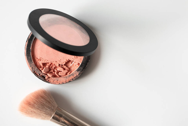 Crushed compact blush and make-up brush on white background with copy space, top view. Simplicity beauty template for banner or poster about decorative cosmetic - Φωτογραφία, εικόνα