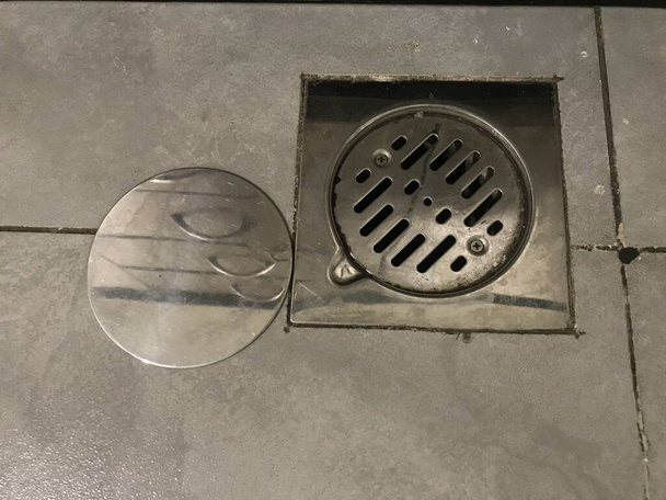 stainless steel floor trap images and fixed on a kitchen floor tile which is new and floor tiles are of ceramic floor tiles non slippery - Photo, Image