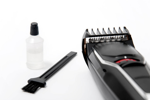 Trimmer, oil and brush on a white isolated background. Beard Care. - Photo, Image