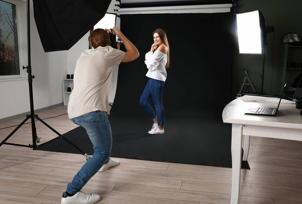 Professional photographer working with model in studio - Photo, Image