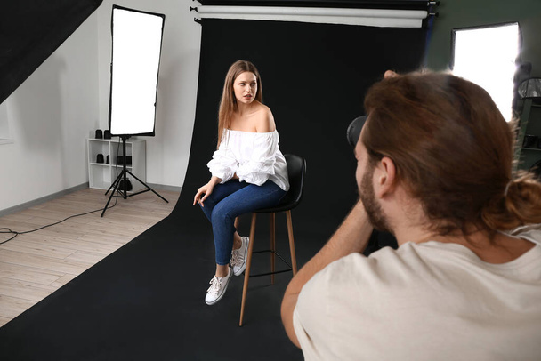 Professional photographer working with model in studio - Foto, immagini