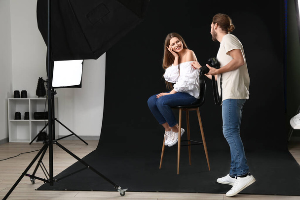 Professional photographer working with model in studio - Foto, immagini