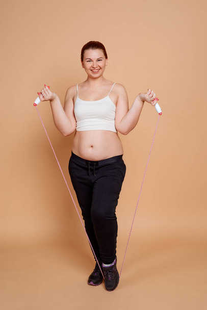 Woman doing jump rope exercises. Fitness workout for weight loss - Photo, image