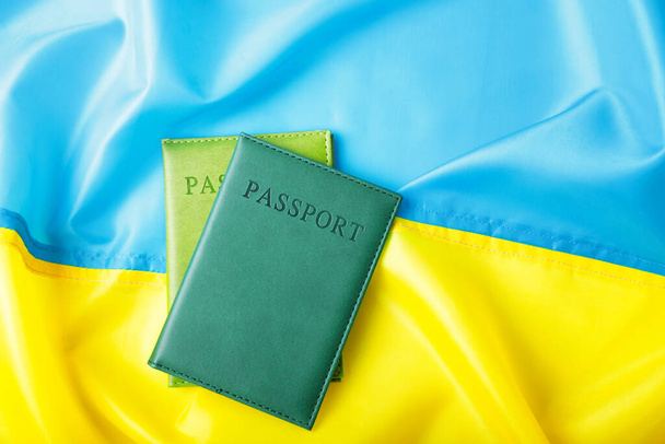 Passports on flag of Ukraine. Immigration concept - Photo, Image
