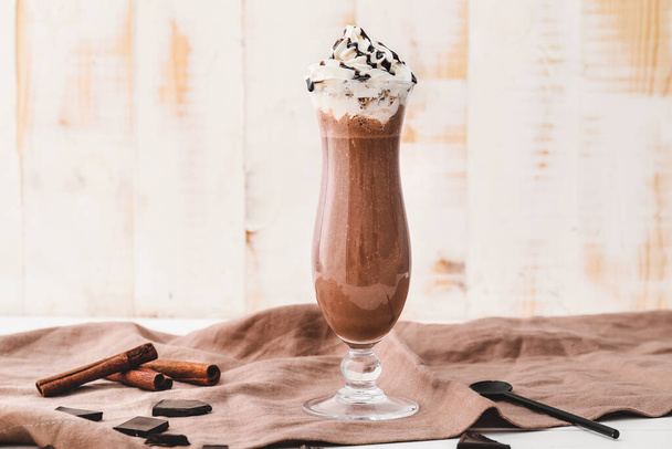 Glass of tasty chocolate milkshake on table - Photo, image