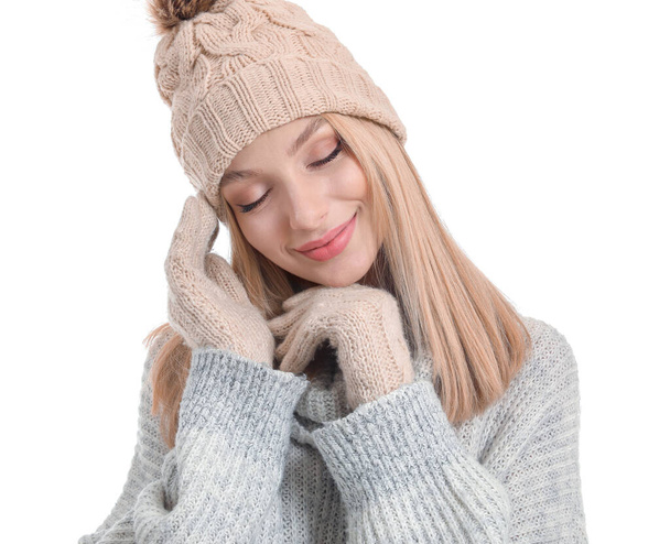 Young woman in warm sweater, hat and gloves on white background - Fotoğraf, Görsel
